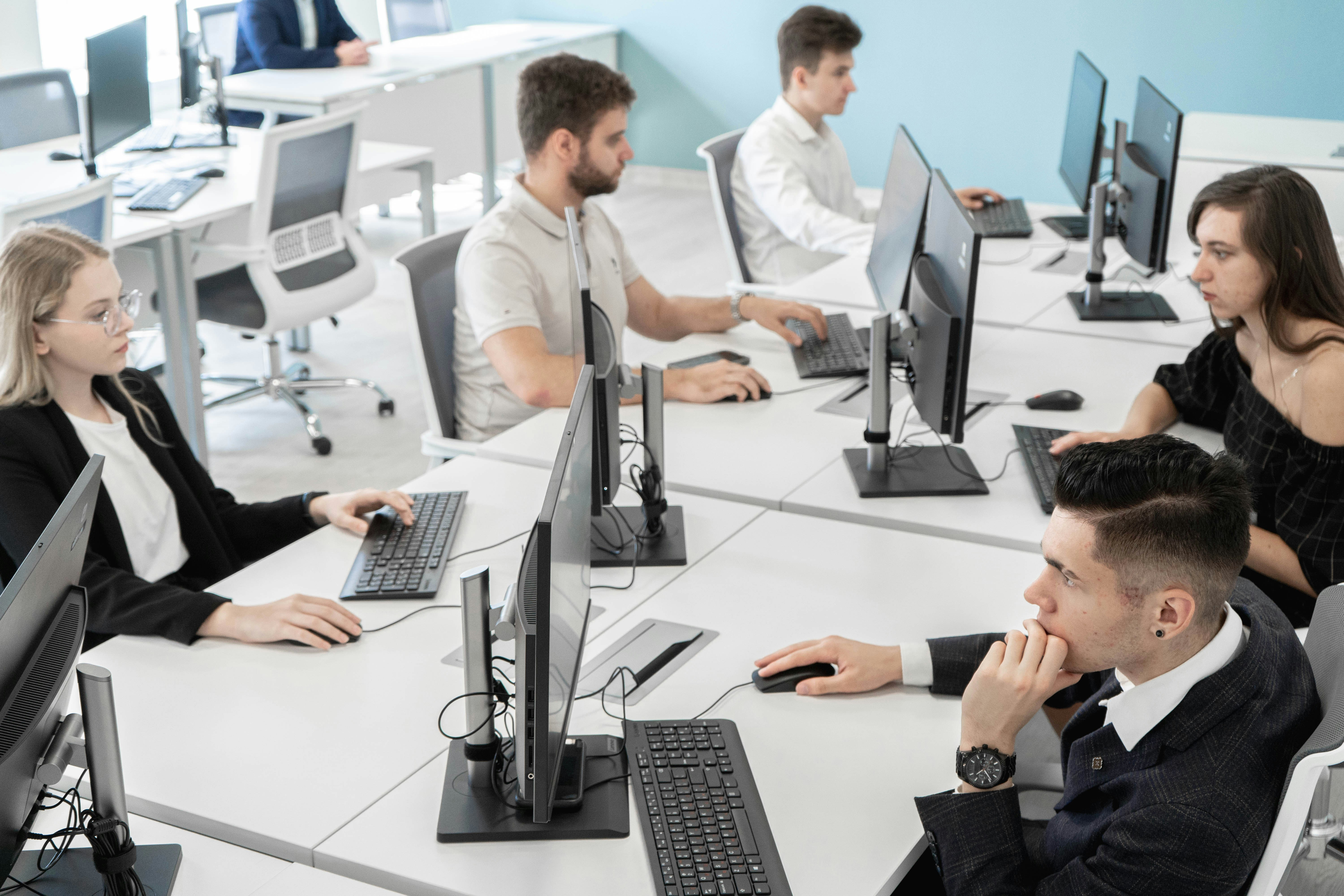 Office team working on computers in a collaborative technology environment
